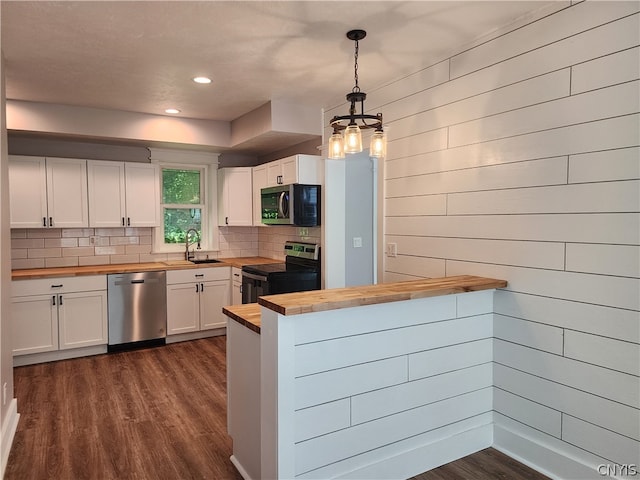 kitchen featuring dark hardwood / wood-style flooring, sink, wood counters, and stainless steel appliances