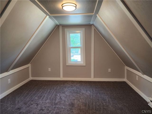 bonus room with vaulted ceiling and carpet floors