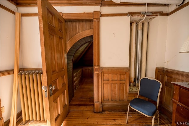 interior space with radiator heating unit and hardwood / wood-style floors