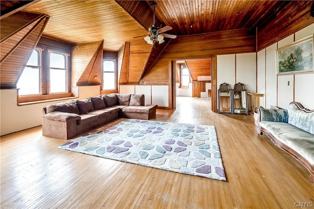 living room with light hardwood / wood-style flooring, ceiling fan, and wooden ceiling