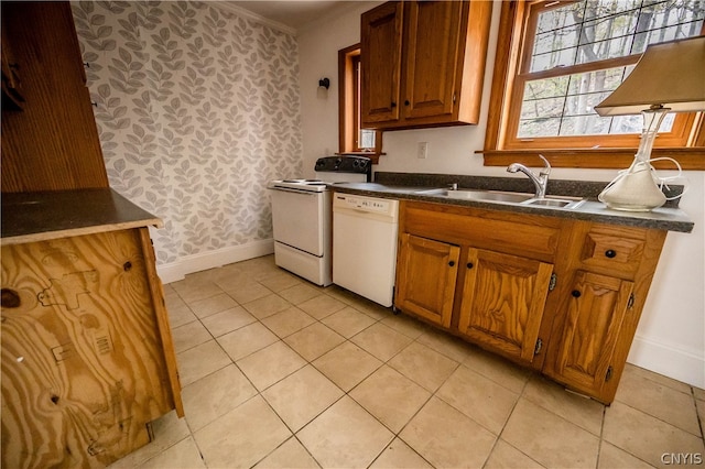 kitchen with crown molding, sink, light tile patterned floors, and white appliances