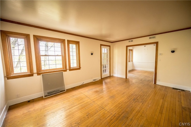 unfurnished room with ornamental molding and light hardwood / wood-style flooring