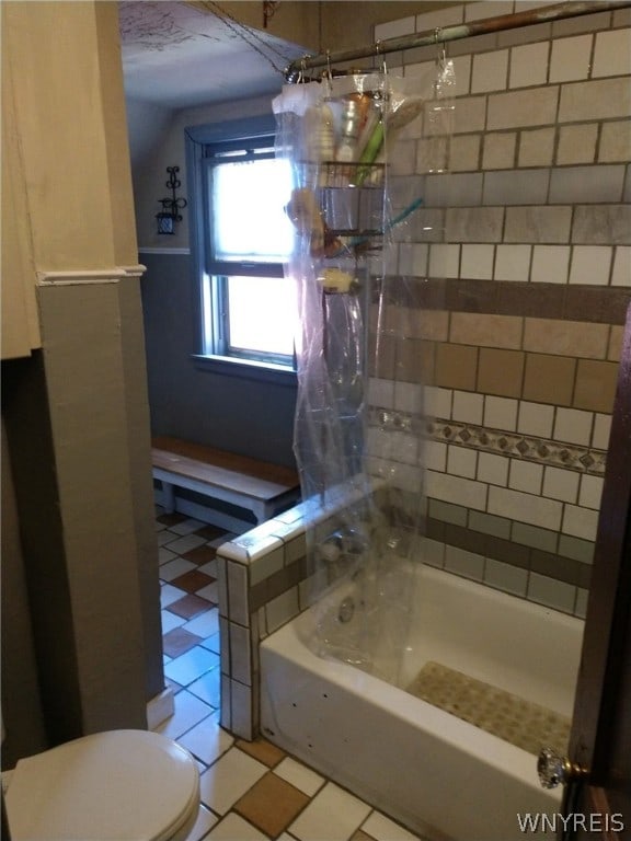 bathroom featuring tile patterned floors, lofted ceiling, toilet, and shower / bath combo with shower curtain