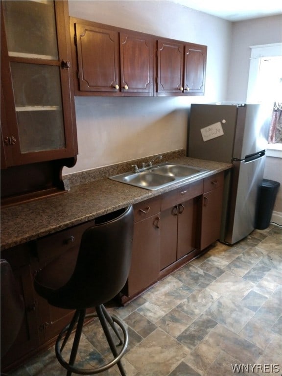 kitchen featuring stainless steel refrigerator and sink