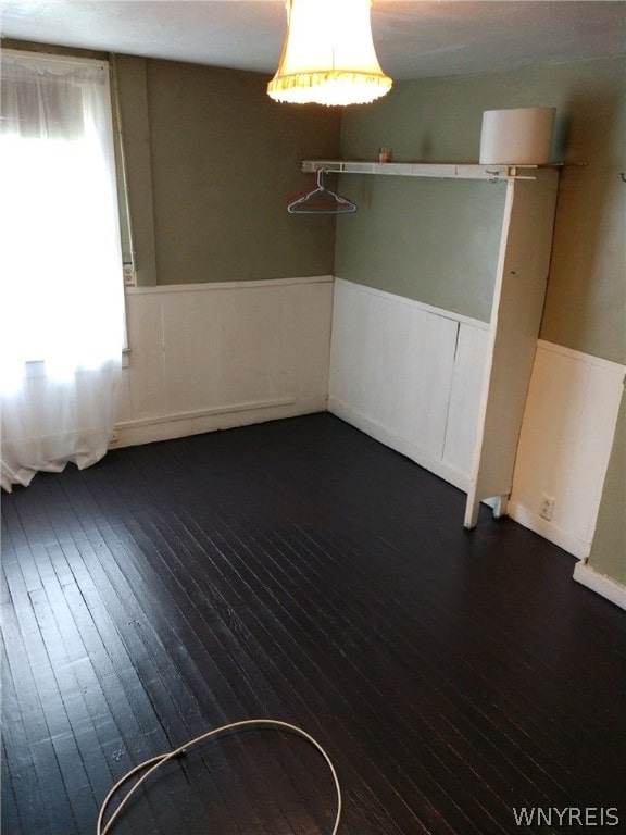 empty room with dark hardwood / wood-style floors