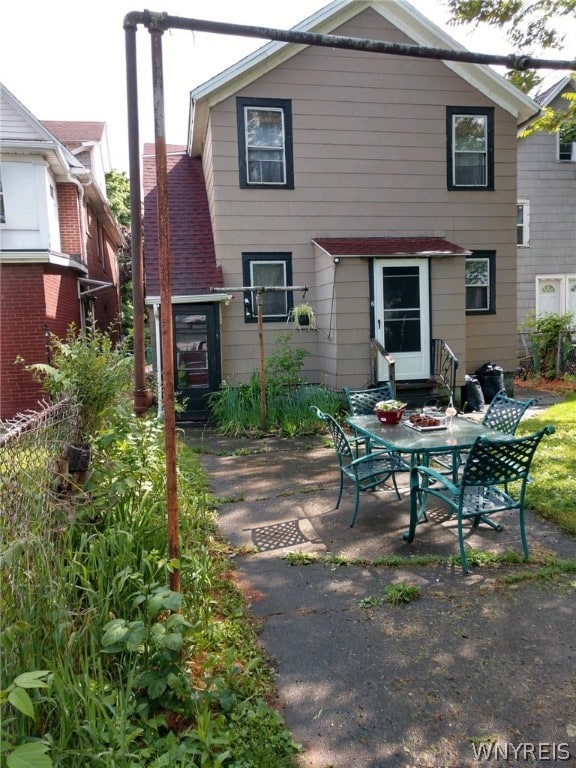 back of property with a patio