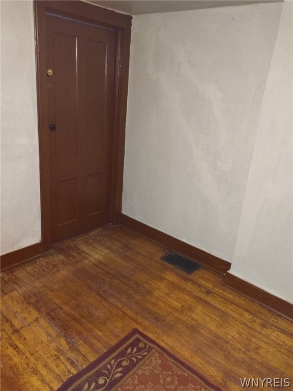 spare room featuring dark wood-type flooring