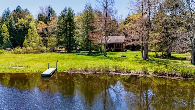 view of dock with a water view and a yard