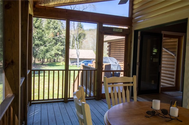 sunroom / solarium featuring lofted ceiling