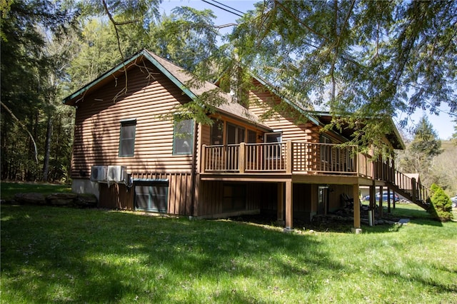 rear view of property featuring a wooden deck and a yard