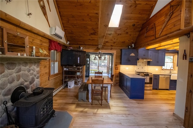 kitchen with light hardwood / wood-style flooring, appliances with stainless steel finishes, beamed ceiling, blue cabinetry, and tasteful backsplash