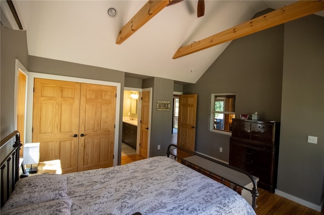 bedroom with a closet, beam ceiling, ensuite bath, high vaulted ceiling, and hardwood / wood-style flooring