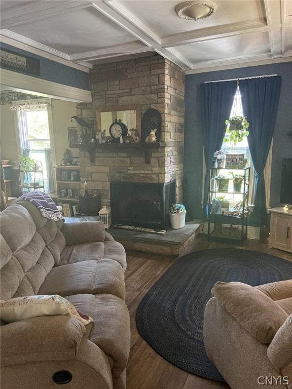 living room featuring a stone fireplace, coffered ceiling, wood-type flooring, and beamed ceiling