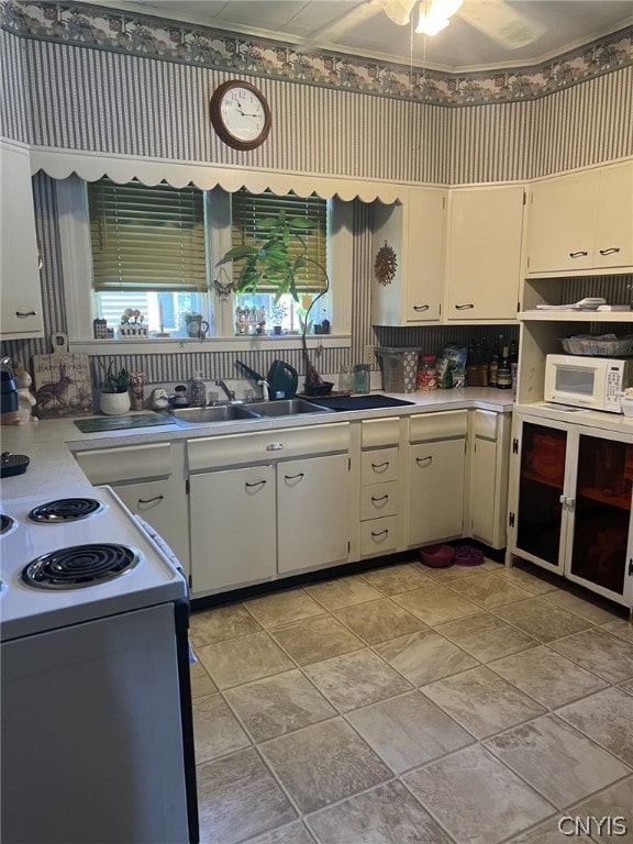 kitchen featuring backsplash, ceiling fan, white cabinetry, white appliances, and light tile floors