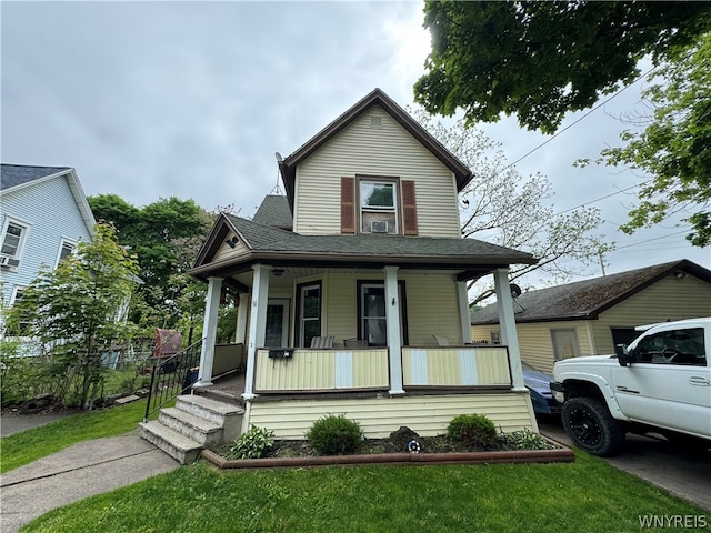 view of front of house with a front yard and a porch