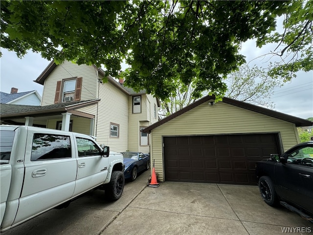 view of side of home with a garage and an outdoor structure