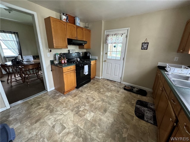 kitchen featuring sink, gas stove, and light tile floors