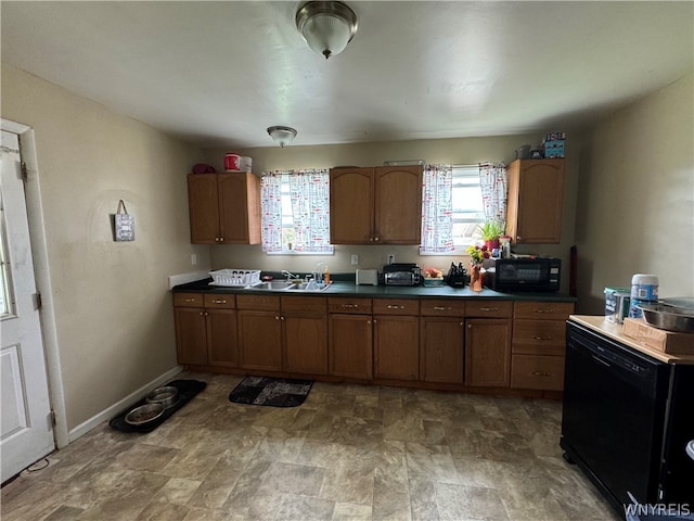 kitchen featuring tile floors, sink, and black appliances