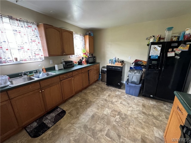 kitchen featuring sink, black appliances, and light tile floors