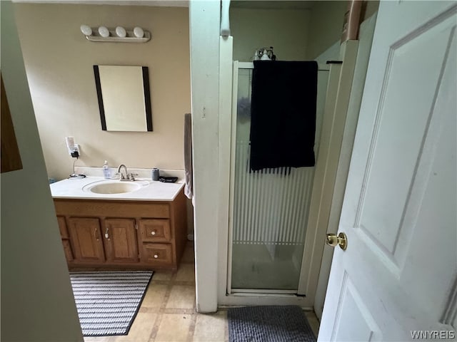 bathroom with tile floors, an enclosed shower, and vanity