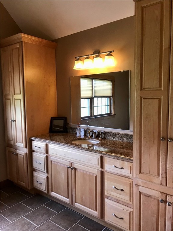 bathroom with tile flooring and vanity