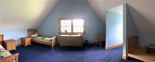 carpeted bedroom with lofted ceiling