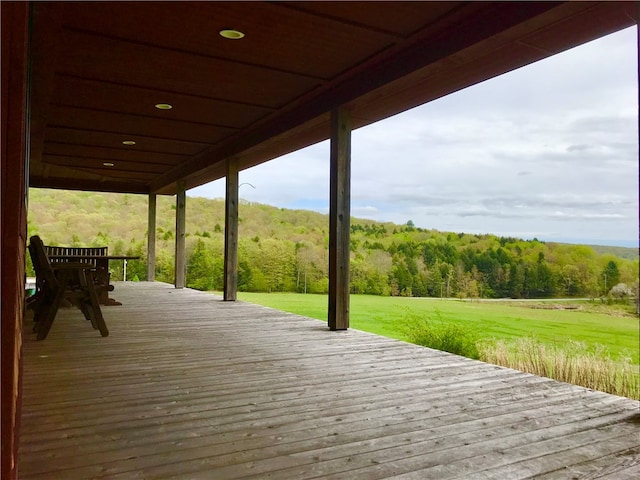 wooden terrace with a lawn