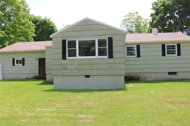 back of property with a lawn