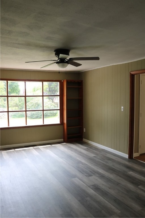 unfurnished room with hardwood / wood-style flooring, a healthy amount of sunlight, and ceiling fan