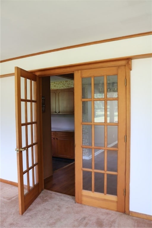 interior space featuring carpet, ornamental molding, and french doors