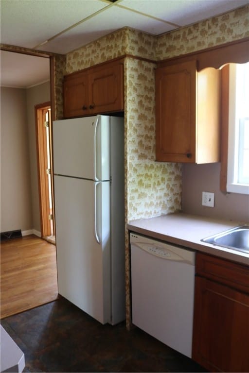 kitchen featuring dark wood-type flooring and white appliances