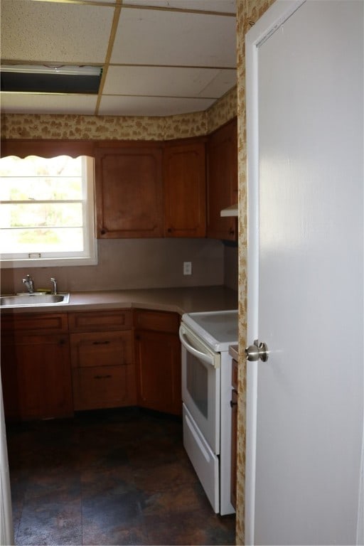 kitchen with sink, electric stove, and a drop ceiling