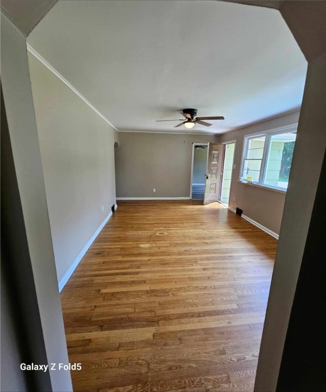 spare room featuring ceiling fan, crown molding, and hardwood / wood-style flooring