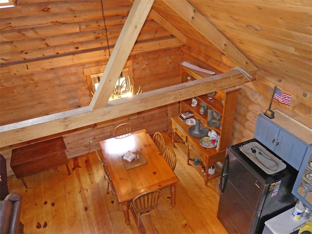 interior space featuring light hardwood / wood-style floors and rustic walls