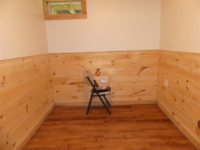 interior space featuring hardwood / wood-style flooring and wood walls