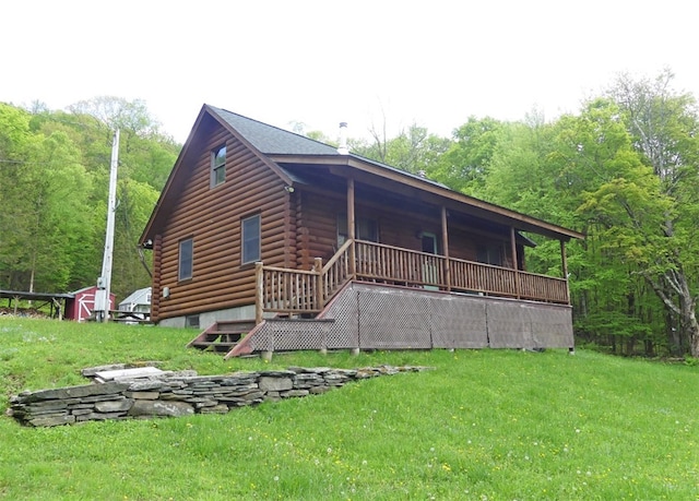 back of house featuring a deck and a lawn