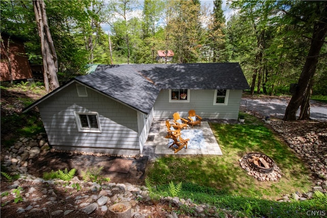 back of property with a patio area and an outdoor fire pit