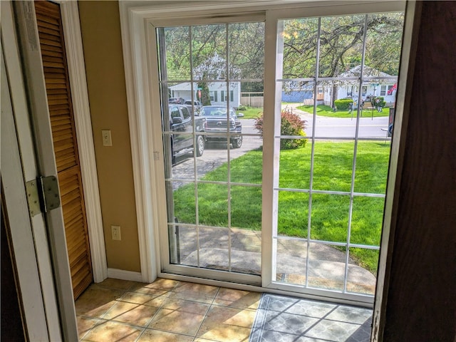 doorway to outside featuring light tile patterned floors