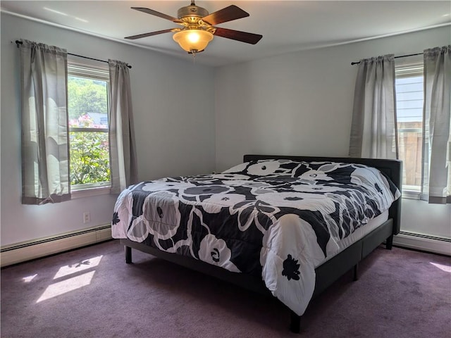 bedroom with ceiling fan, dark carpet, and a baseboard heating unit