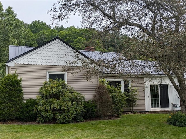 view of property exterior featuring a lawn