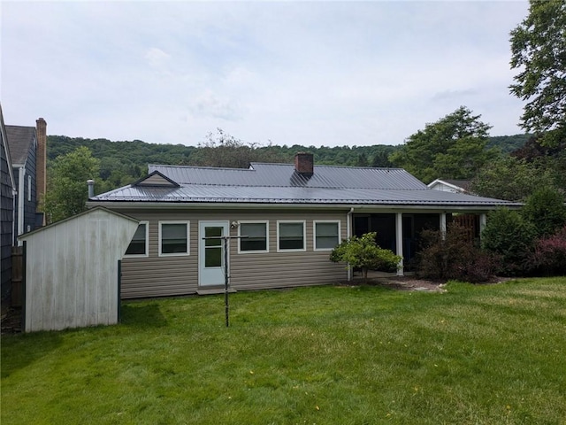 rear view of house with a yard