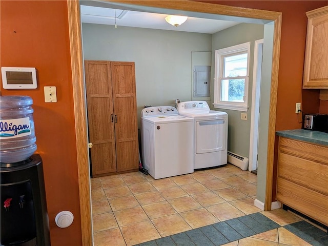 laundry room featuring baseboard heating, electric panel, washer and clothes dryer, and light tile patterned floors