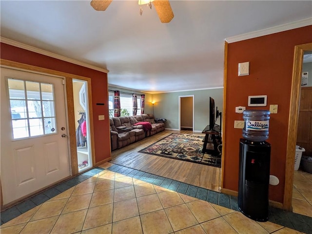 tiled living room featuring ceiling fan and ornamental molding