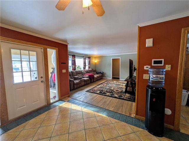 tiled living room featuring ceiling fan and ornamental molding