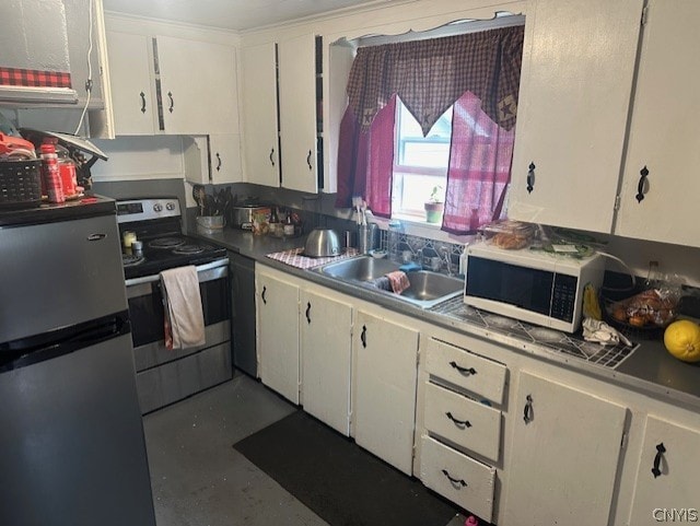 kitchen with appliances with stainless steel finishes, sink, and white cabinets