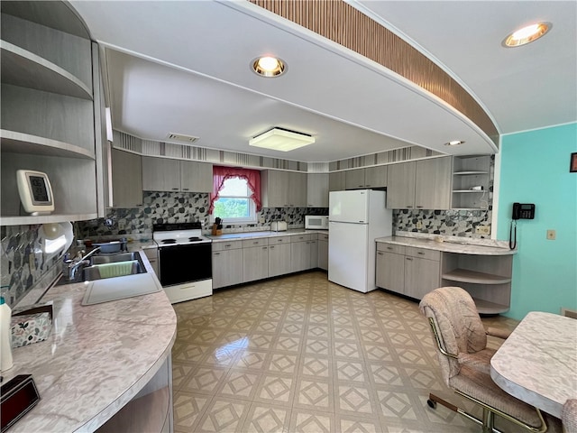 kitchen featuring white appliances, sink, and gray cabinetry