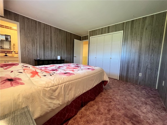 bedroom with carpet, a closet, and wood walls