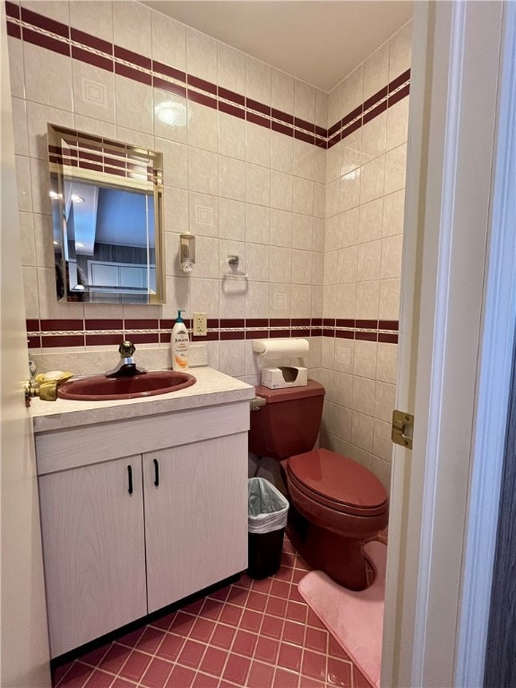 bathroom featuring tile walls, vanity, tasteful backsplash, tile patterned floors, and toilet