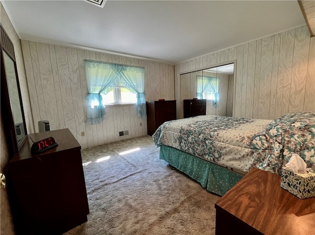 bedroom featuring a closet, carpet, and wood walls