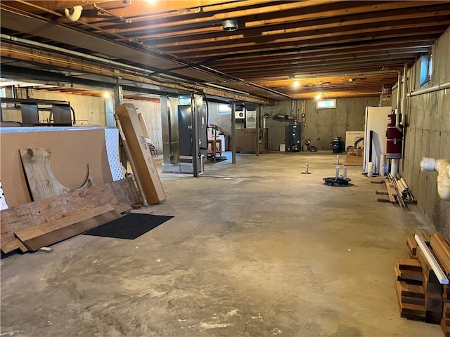 basement with white refrigerator and water heater